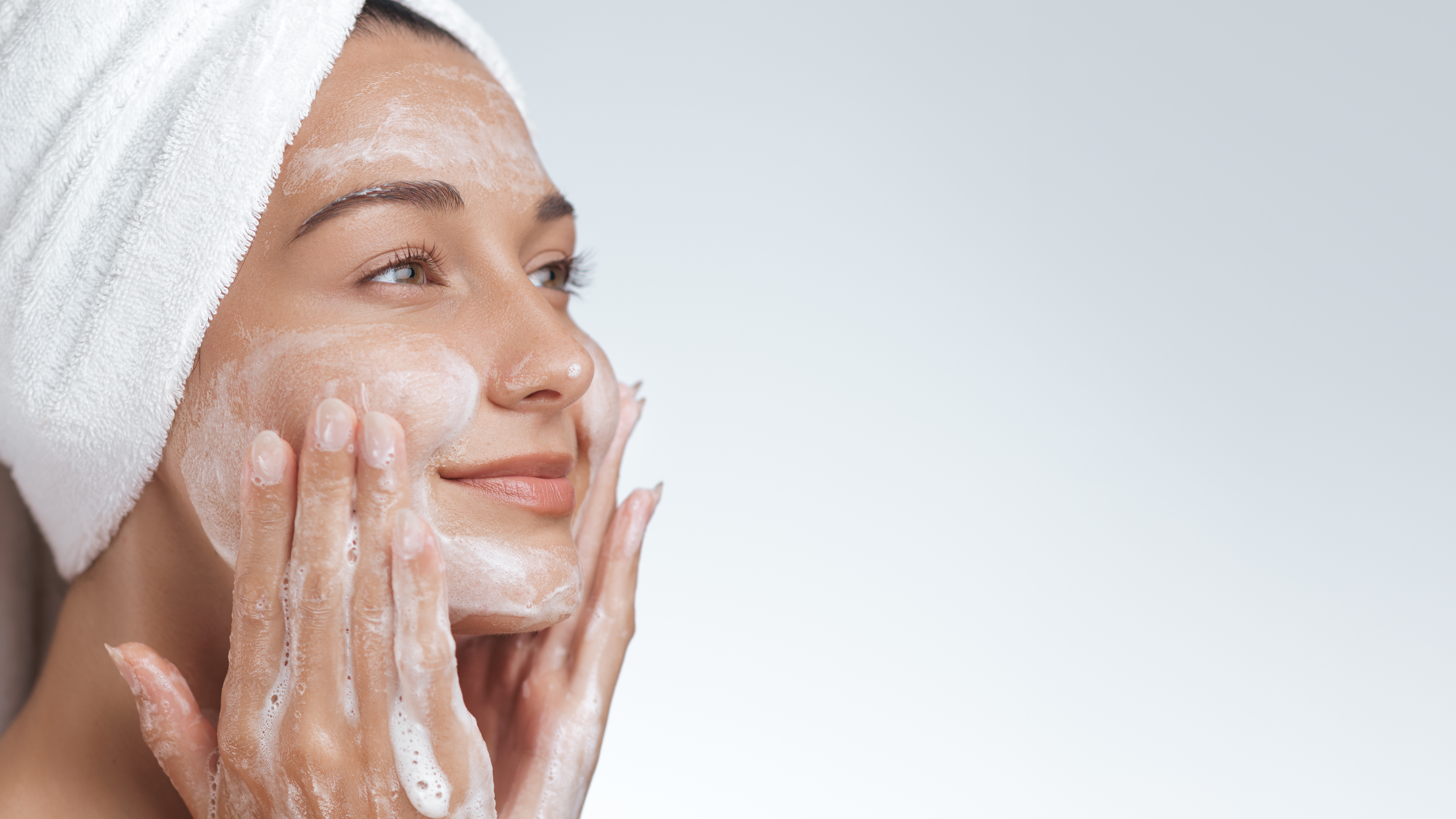 Mulher lavando o rosto com o Smart Gel de Limpeza Ultra Regener